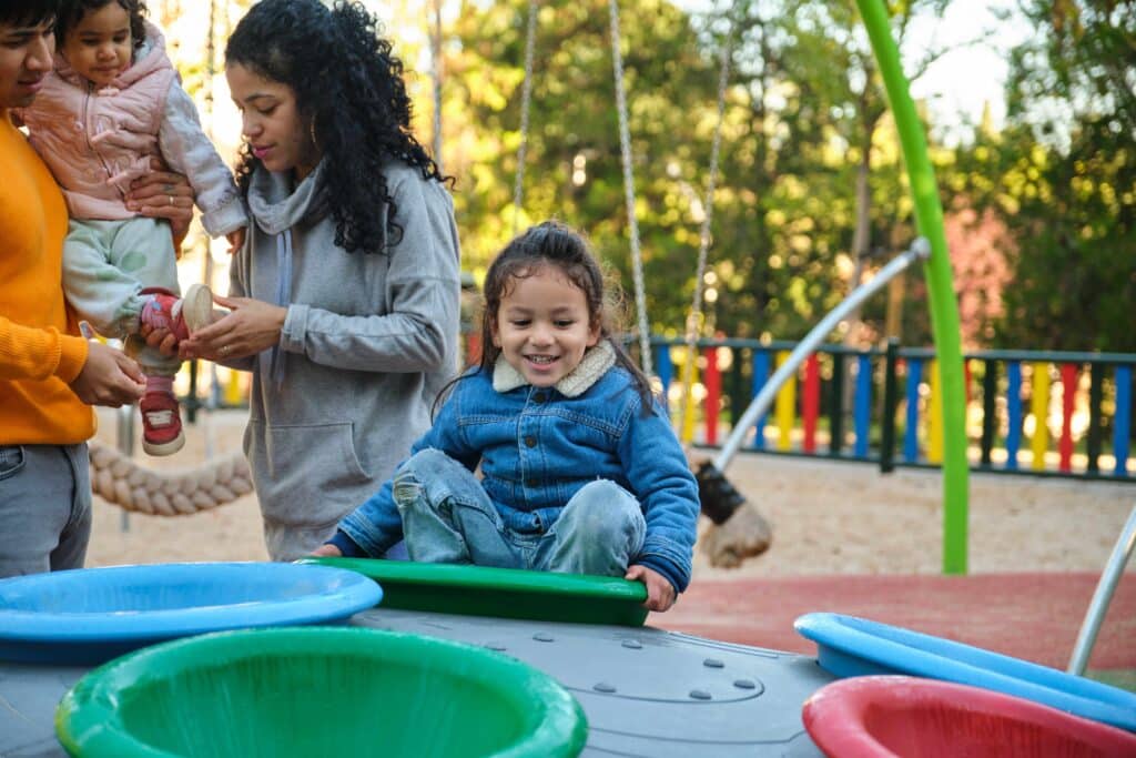 Latin boy playing on a playground during recesses.