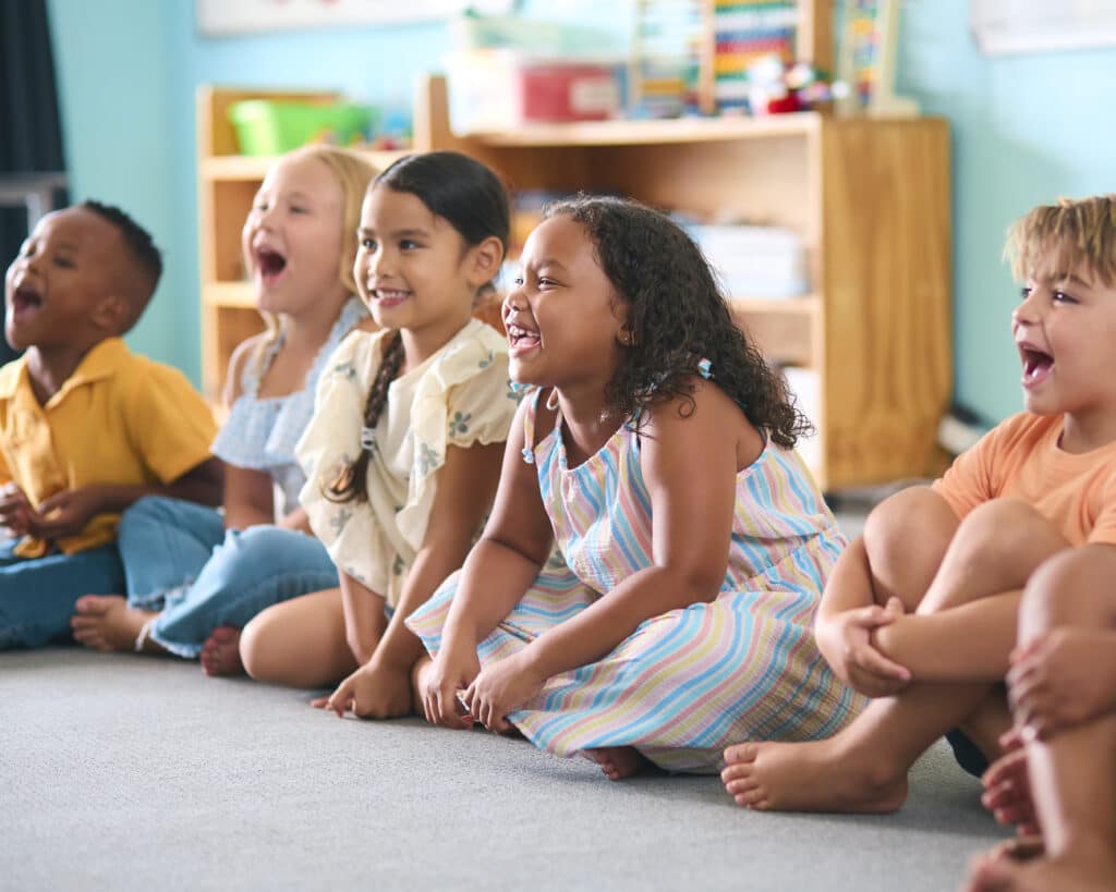 Line of kids enjoying a lesson during preschool at The Till Academy in Red Oak, TX.