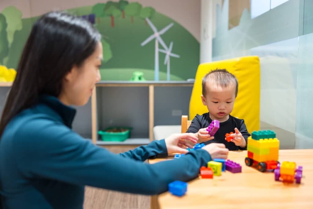 Mother playing with her child at daycare in Red Oak, TX.